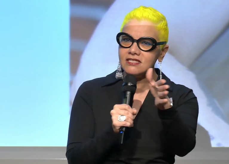Mona Eltahawy speaking into a microphone